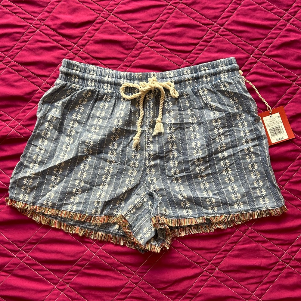 Blue and white Mossimo floral shorts with fringe hem & drawstring bow tie.